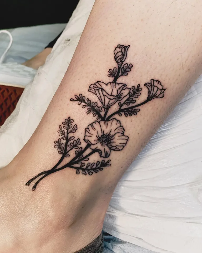 California poppy and wildflower tattoo on the lower leg by Melissa at Golden Child Tattoo in Escondido