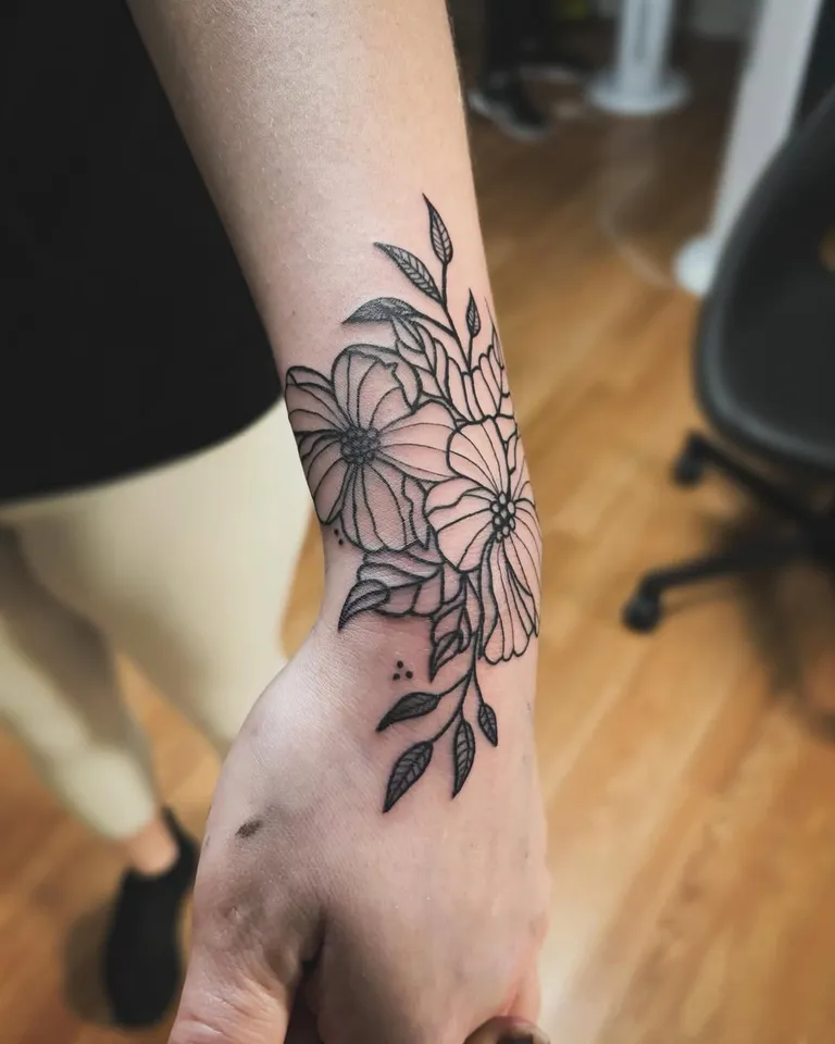 Floral tattoo wrapping the wrist and hand by Melissa at Golden Child Tattoo in Escondido