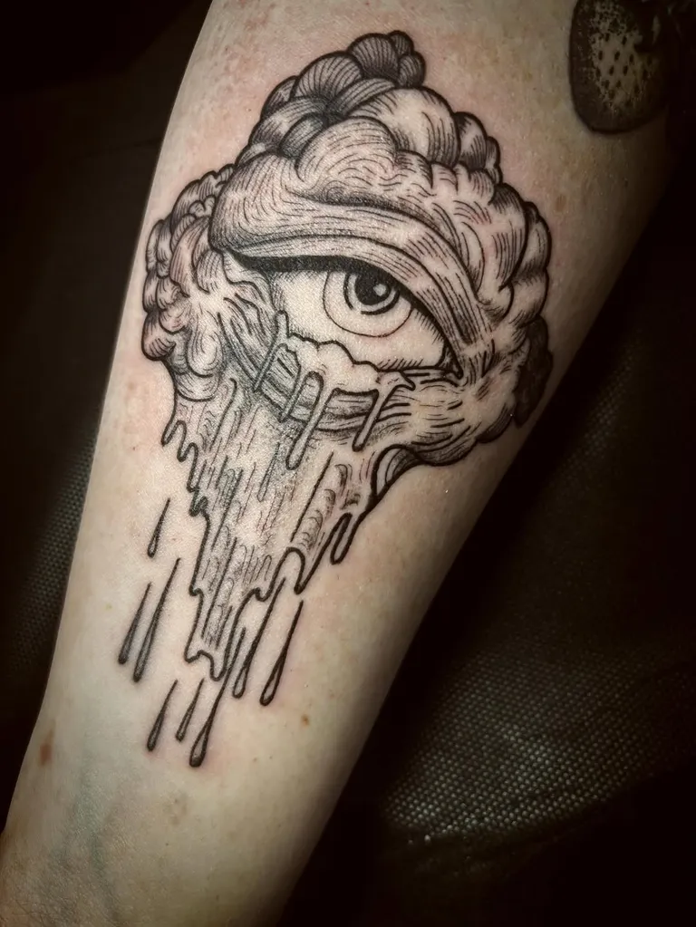 Storm cloud with an eye and falling rain, tattooed on the forearm by Melissa at Golden Child Tattoo in Escondido