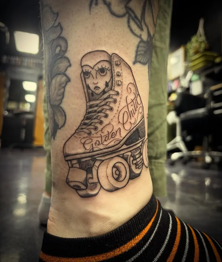 Roller skate tattoo with Golden Child lettering on the lower leg by Melissa at Golden Child Tattoo in Escondido