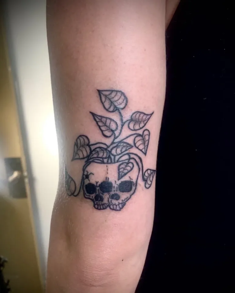 Skull planter with leaves tattoo on the back of the arm by Melissa at Golden Child Tattoo in Escondido