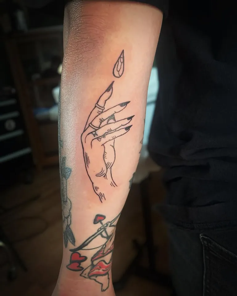 Hand with long nails tattoo on the forearm by Melissa at Golden Child Tattoo in Escondido