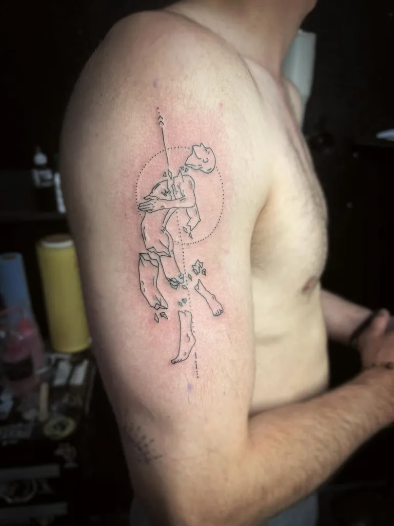 Surreal fine line figure tattoo on the upper arm by Melissa at Golden Child Tattoo in Escondido