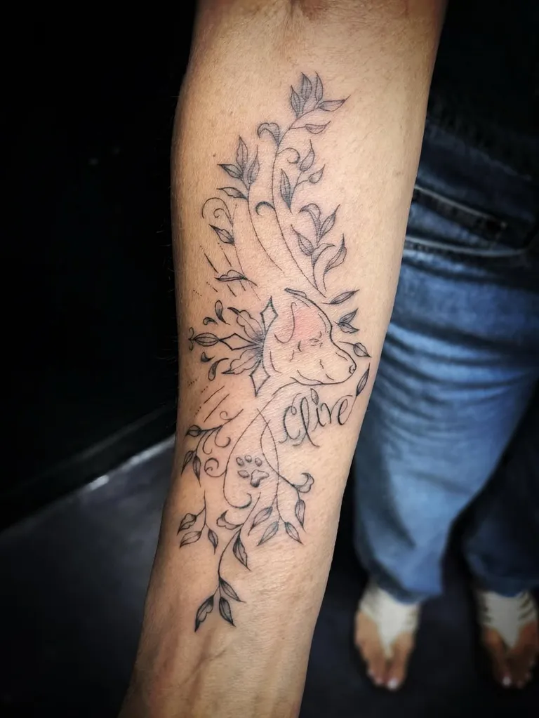 Fine line vine forearm tattoo with a dog outline and a script name by Melissa at Golden Child Tattoo in Escondido