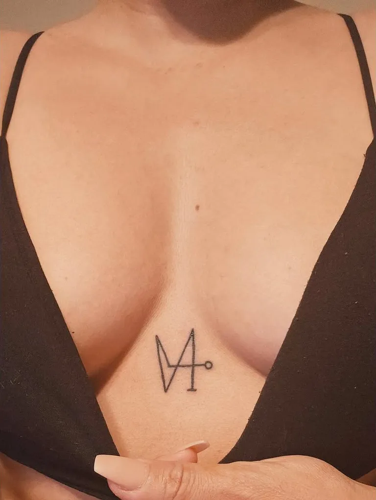 Small fine line sigil tattoo on the sternum by Melissa at Golden Child Tattoo in Escondido