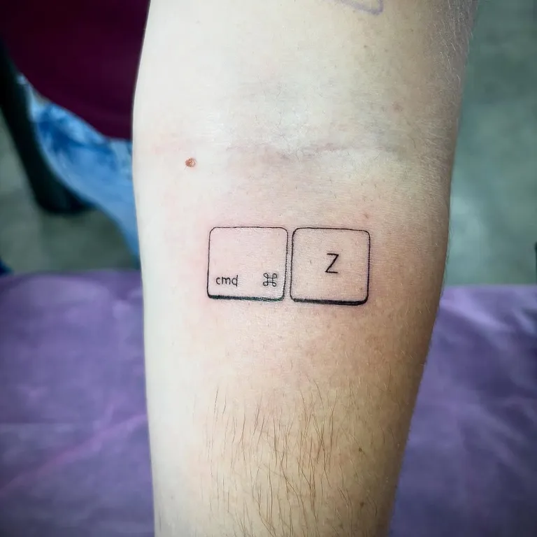 Minimalist keyboard key tattoo on the forearm by Melissa at Golden Child Tattoo in Escondido