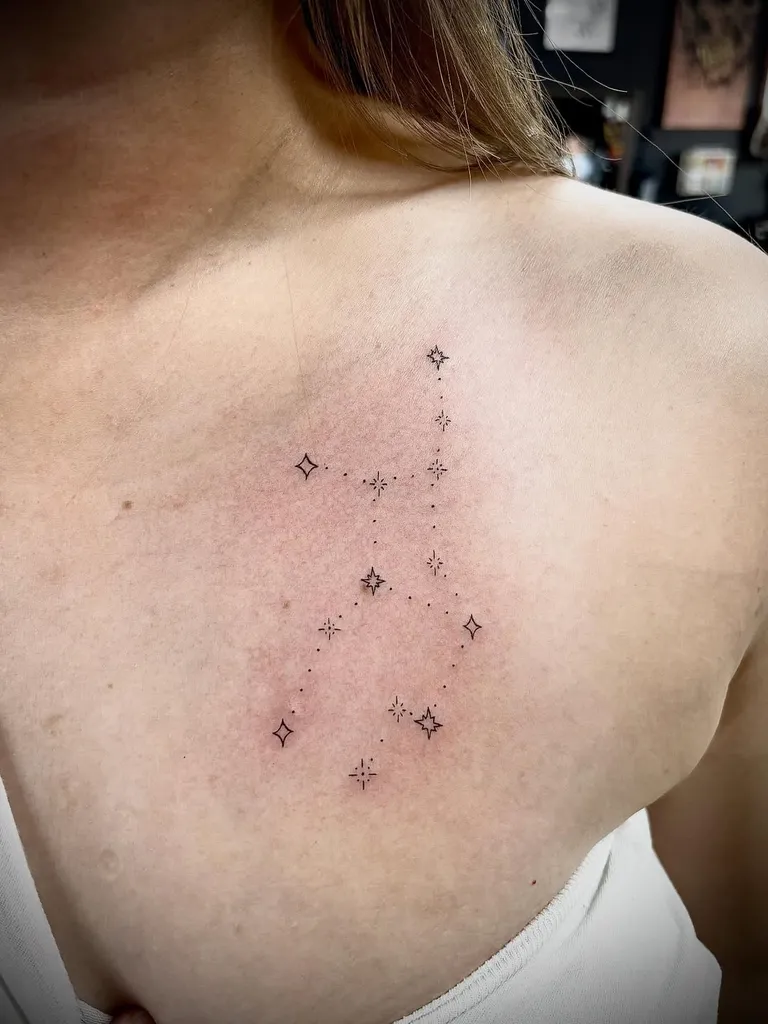 Tiny constellation tattoo on the upper back by Melissa at Golden Child Tattoo in Escondido