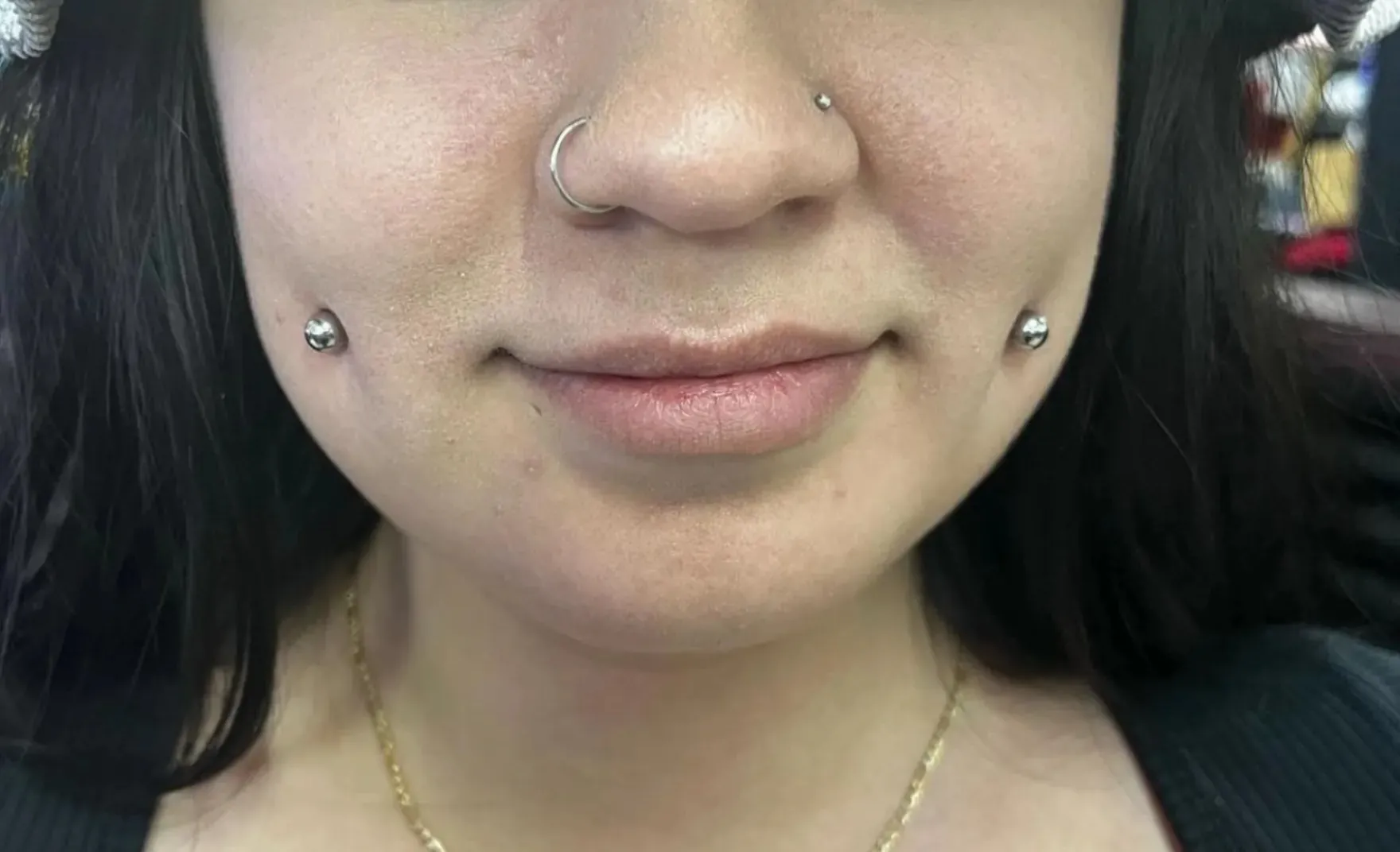 Cheek piercing by Wheels at Golden Child Tattoo in Escondido