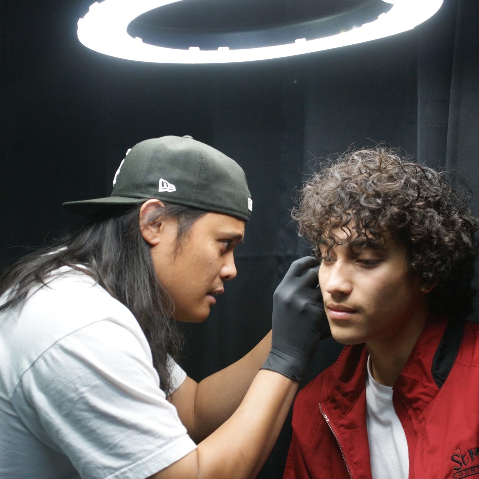 Golden Child piercer performing a halo piercing