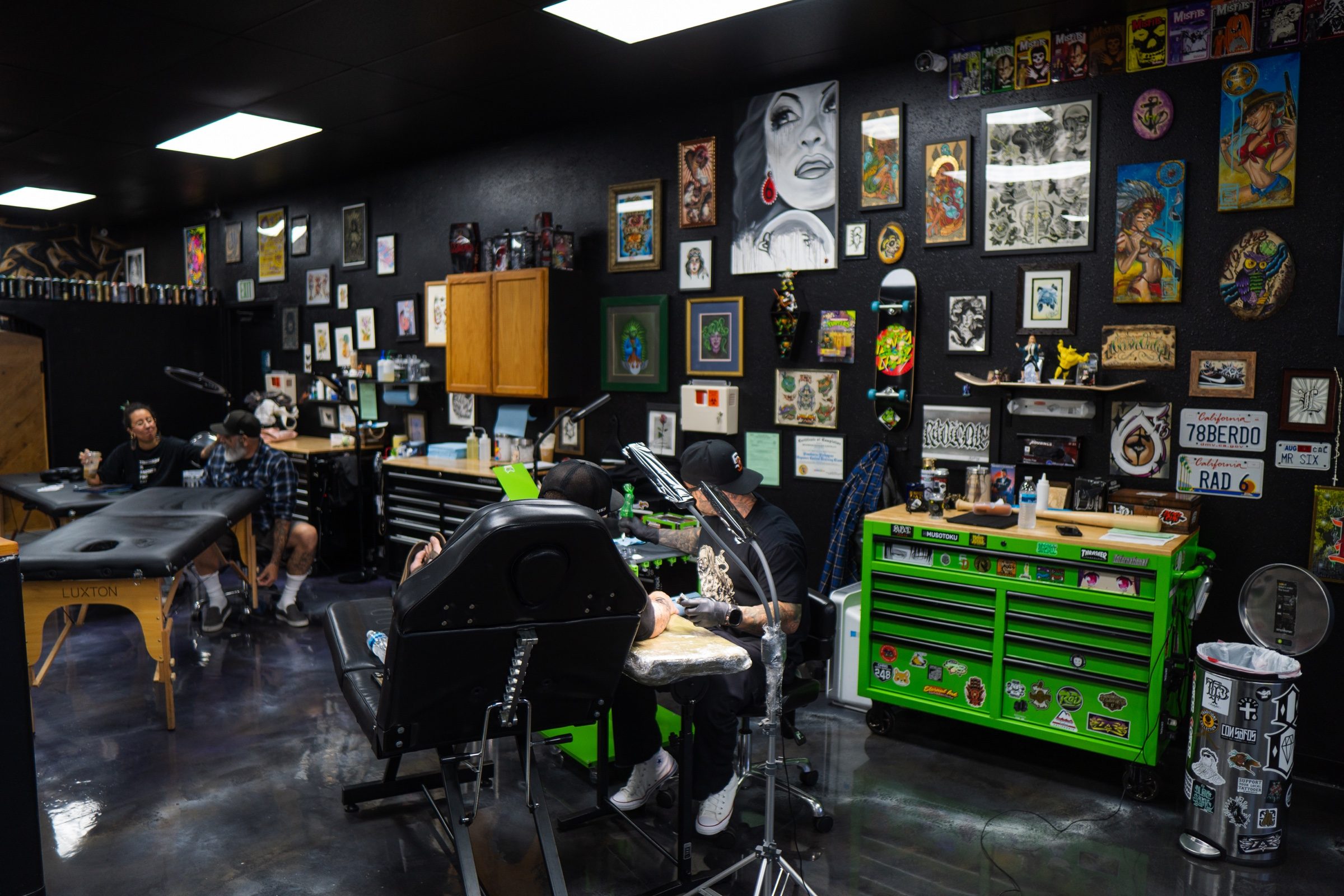 Side wall art and a work in progress inside Golden Child Tattoo and Piercing in Escondido