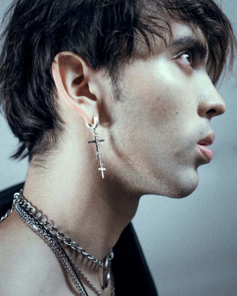 Man with dangle style cross earring